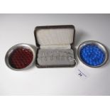 A cased set of twelve silver Napkin Numbers, and a pair of silver Coasters with bubbled blue and red