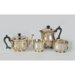 A George V silver four piece Tea and Coffee Service with cut card and hammered design, London