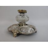 An Elkington and Co plated Ink Bottle Stand, central glass ink bottle with hinged lid with