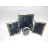 Three modern silver rectangular Photograph Frames with beaded rims and a plain oval Frame