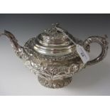 A William IV circular silver Teapot with floral and scroll embossing, presentation inscription,