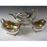 A George III silver three piece Tea Service of boat shape with gadroon and scallop border, anthemion
