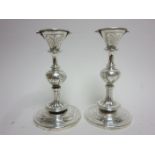 A pair of Tiffany & Co silver Candlesticks embossed three portrait masks to the knop stems on