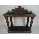 A Late Victorian Oak Hall Stick Stand with Raised Centre Small Drawer having Lion Mask Carving,