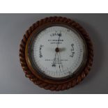 An Edwardian Circular Aneroid Barometer with Rope Border and Enamelled Dial Inscribed HY Robinson.