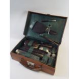 An Edwardian Leather Travelling Case Containing Ebony, Silver Plate and Glass, Brushes,