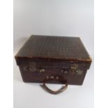 A Late 19th Century Lidded Crocodile Skin Fitted Travelling Case Containing Various Silver Topped