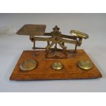 A Set of Brass Postage Scales on Wooden Plinth with Inset Weights.