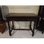 A Carved Oak Side Table with Single Top Drawer and Bobbin Stretcher.