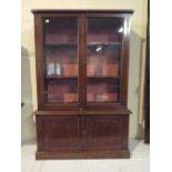 An Edwardian Mahogany Miniature Library Bookcase with Glazed Top Section and Cupboard Base.