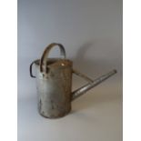 A Galvanized Watering Can.