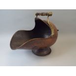 A Victorian Copper Helmet Shaped Coal Scuttle with Brass Carrying Handles.