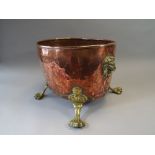 A Victorian Copper Log or Coal Bucket with Brass Lion Handles and Claw Feet.