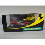 A Scalextric C 2271 Caterham 7 Road Trim in Silver and Red Livery Registration Number V82 GMR.