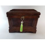 An Oak and Burr Walnut Work Box with Panelled Front, Corner Pilaster Supports and Bracket Feet.