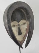 A Gabonese Tribal Kwele Mask, with horned protrusions, approx 32 cms