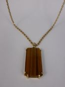 A 9ct Yellow Gold Tigers Eye Pendant, approx 3 x 1.5 mm, 5.0 gms suspended on a 9 ct yellow gold