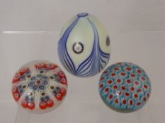 Two Millefiori Paperweights, the first with dense red and blue cluster of canes, the second with