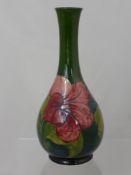 A Moorcroft Slim Neck Vase, 'Hibuscus design', with Royal Warrant label to verso, 'Potters to the