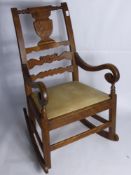 A Victorian Fireside Rocking Chair, decorative carving to back panel, swept arms, approx 1 meter