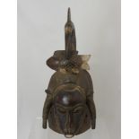 A West African (Cote d' Ivoire) Baule Mask, depicted with frontal buffalo horns and a crane with a