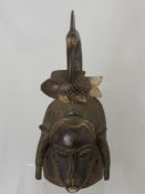 A West African (Cote d' Ivoire) Baule Mask, depicted with frontal buffalo horns and a crane with a