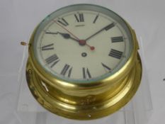 An English Made Brass Marine Clock, white enamel dial.