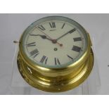 An English Made Brass Marine Clock, white enamel dial.