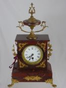 A Reproduction Red Marble Clock, with white enamel Roman numeral dial, gilt supports and