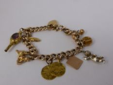 A Lady's Vintage 9ct Yellow Gold Identity Bracelet, heart shaped clasp, with ten gold charms, approx