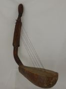 A Warega (Democratic Republic of Congo) Wood and Hide Harp, the pillar of the harp in the form of