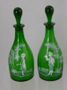 A Pair of Green Glass 'Mary Gregory' Decanters and Stoppers, with white enamel decoration, approx 30