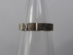 A Lady's 18ct White Gold Bark Finish Wedding Band, mm PP & P, size P, approx 3.9 gms