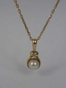 A Yellow Gold Cultured Pearl and Diamond Pendant, suspended on a 9ct yellow gold chain, Pearl 6.7