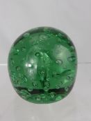 A Large Green Glass Dumper Weight, with bubble inclusions.