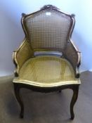 A French 'Louis Seize' Style Gilt Wood and Cane Salon Chair, with swept arms and laurel decoration