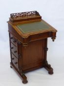 A Victorian Burr Walnut Davenport, the stationery compartment with pierced carved gallery, above a