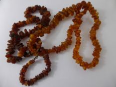 Two Rough Amber Necklaces, approx 66 cms and 60 cms.