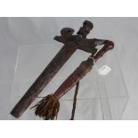 An Antique North African Dagger, the dagger having leather handle and tooled leather scabbard with