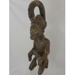 A West African Yoruba Wood Carved Ancestral Figure, depicted kneeling, approx 63 cms