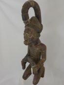 A West African Yoruba Wood Carved Ancestral Figure, depicted kneeling, approx 63 cms