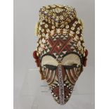 A Democratic Republic of Congo Kuba Mask, Polychrome kaolin decoration to the face, with applied