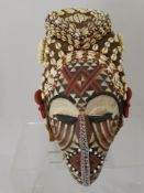 A Democratic Republic of Congo Kuba Mask, Polychrome kaolin decoration to the face, with applied