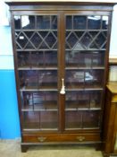 An Antique Mahogany Glazed Fronted Bookcase, the bookcase having mixed glazed panels with six