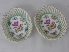 A Pair of Continental Porcelain Trinket Dishes, with ribbon decoration and hand painted with
