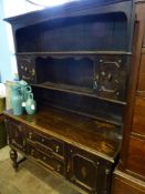 A Vintage Tudor Style Cottage Dresser, having two shelves with cupboards to top and two drawers