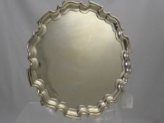 A Silver Salver, with decorative pie crust edge on three scroll feet. Sheffield hallmark, mm