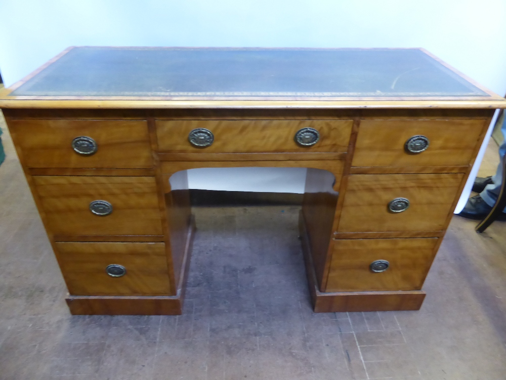 An Antique Satinwood Knee Hole Desk, the desk having slim proportions with green leather tooled top,