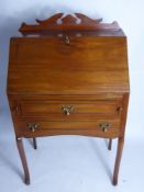 An Edwardian Mahogany Drop Front Bureau, two drawers with brass drop handles, supported on