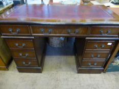 A Mahogany Serpentine Front Reproduction Knee Hole Desk, having red leather tooled insert, with